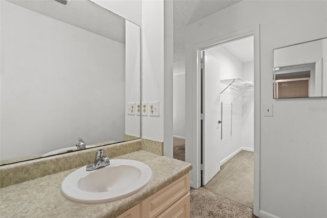 bathroom with vanity and a textured ceiling