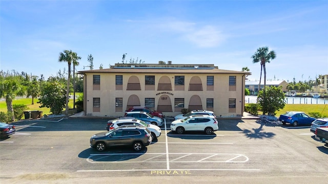 view of building exterior with uncovered parking