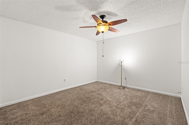 carpeted spare room featuring ceiling fan and a textured ceiling