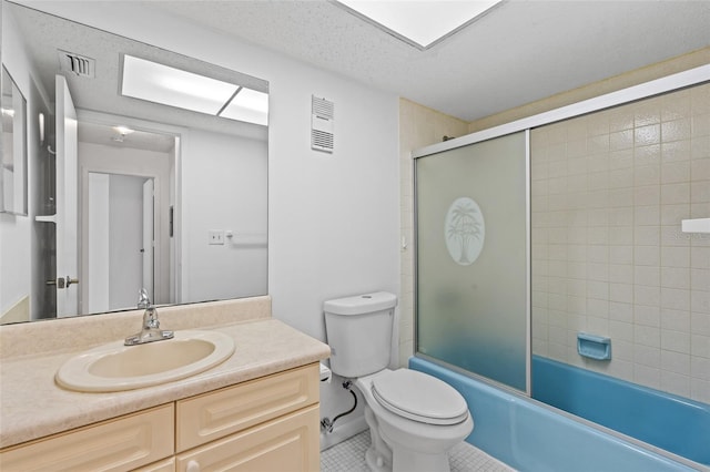 full bathroom featuring toilet, a textured ceiling, tile patterned floors, enclosed tub / shower combo, and vanity