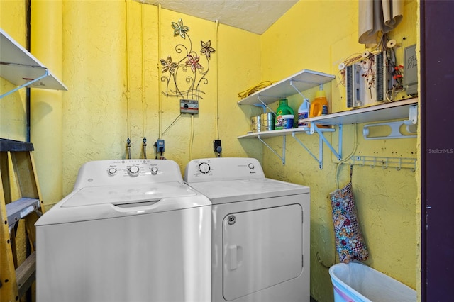 laundry room featuring separate washer and dryer and a textured ceiling