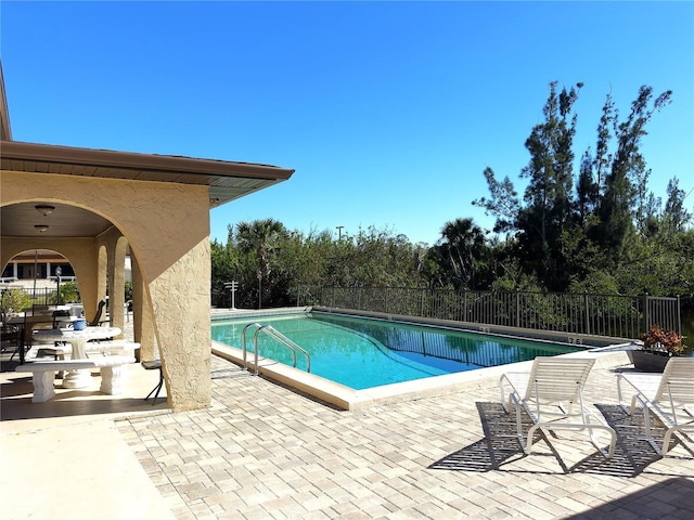 pool featuring a patio area and fence