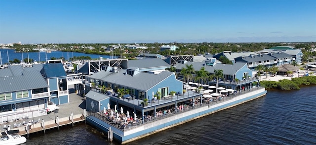 drone / aerial view featuring a water view and a residential view