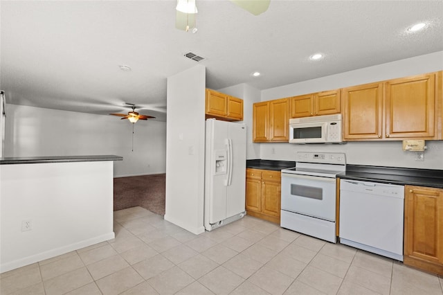 kitchen featuring light tile patterned floors, dark countertops, visible vents, a ceiling fan, and white appliances