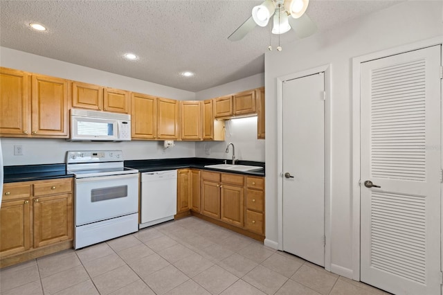 kitchen with sink, a textured ceiling, white appliances, light tile patterned flooring, and ceiling fan