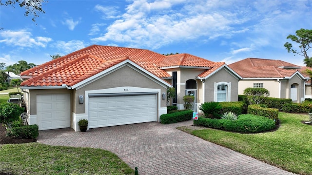 mediterranean / spanish home featuring a garage