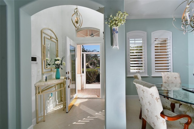 interior space featuring crown molding and light tile patterned floors