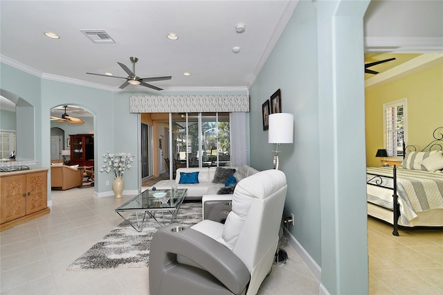 living room with light tile patterned floors, a healthy amount of sunlight, and ornamental molding