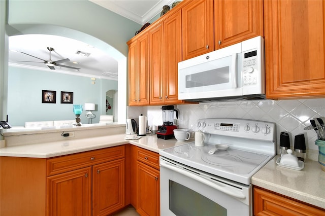 kitchen featuring tasteful backsplash, ceiling fan, crown molding, and white appliances