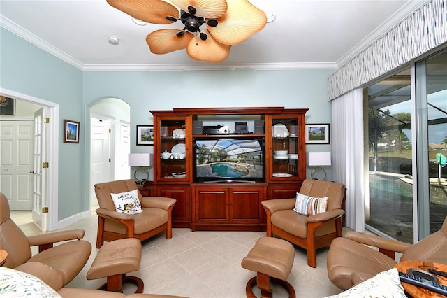 sitting room with ceiling fan, light tile patterned floors, and ornamental molding