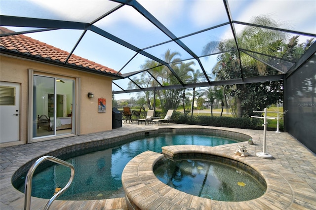 view of pool with a patio area, a lanai, and an in ground hot tub