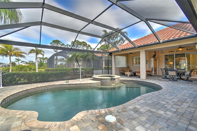 view of swimming pool with ceiling fan, a patio area, an in ground hot tub, and glass enclosure