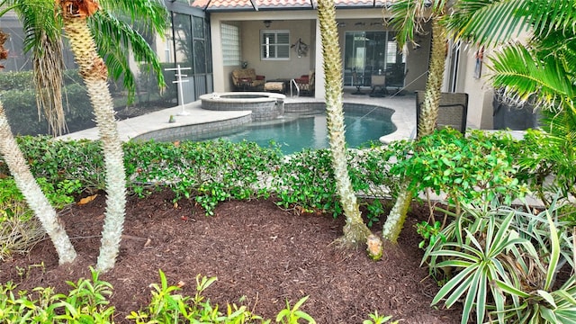 view of pool featuring a patio area and an in ground hot tub