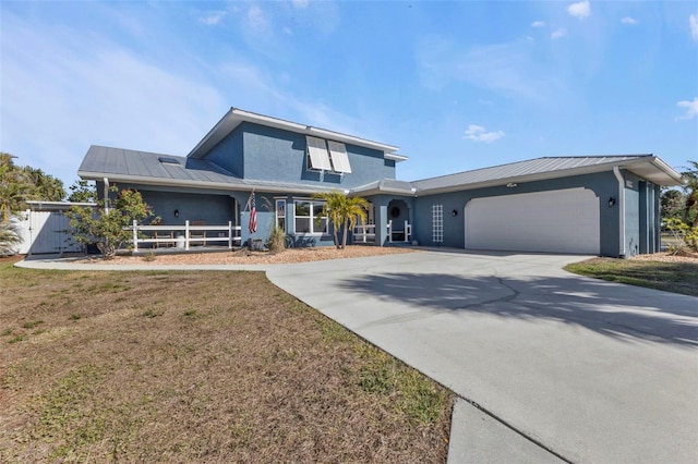 view of front of home with an attached garage, driveway, and stucco siding