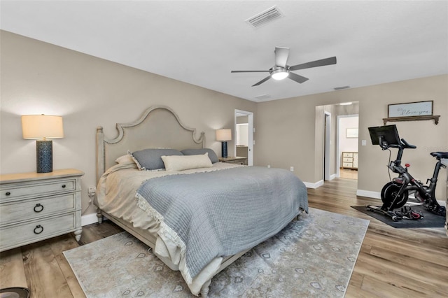 bedroom featuring visible vents, a ceiling fan, dark wood-type flooring, and baseboards