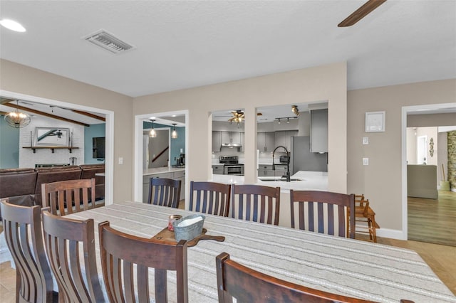 dining area with visible vents, baseboards, and ceiling fan