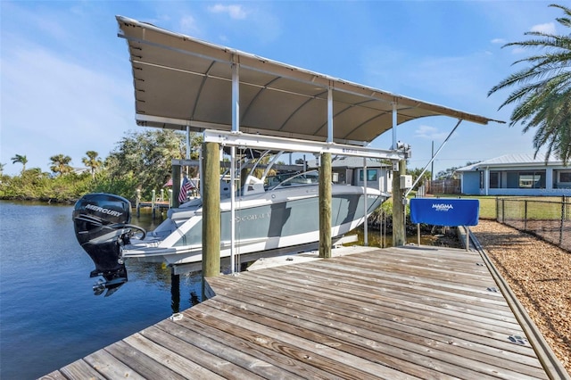 dock area featuring a water view, boat lift, and fence