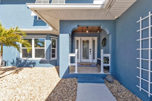 property entrance with stucco siding