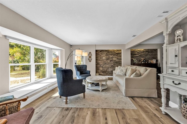 living area featuring visible vents and light wood-style flooring