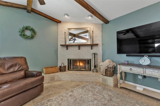 living area with beam ceiling, visible vents, a brick fireplace, and a ceiling fan