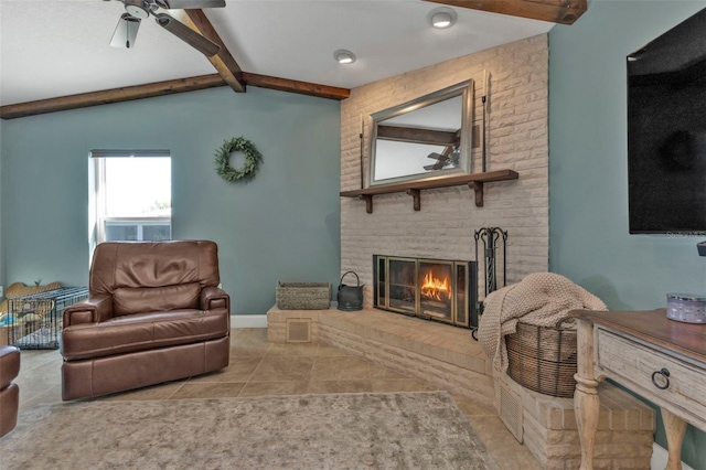 tiled living area featuring a fireplace, vaulted ceiling with beams, baseboards, and a ceiling fan