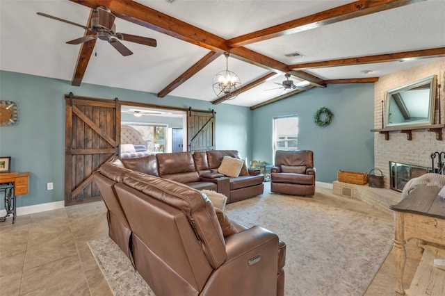 living area featuring ceiling fan with notable chandelier, lofted ceiling with beams, a barn door, a fireplace, and baseboards