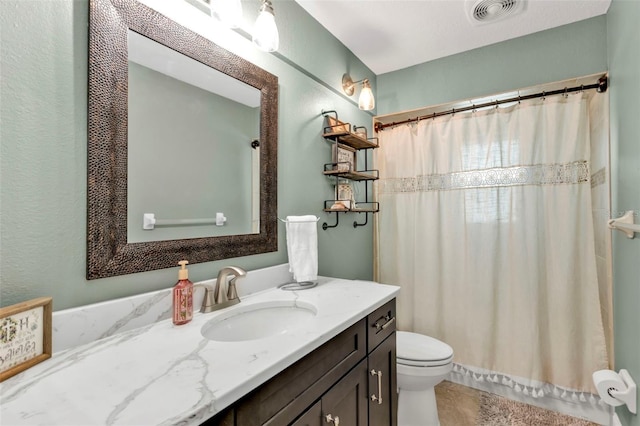 bathroom with visible vents, curtained shower, toilet, and vanity