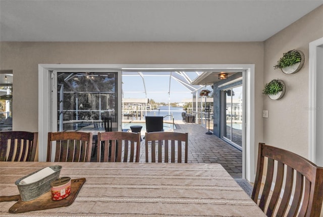 dining space featuring a water view and a sunroom