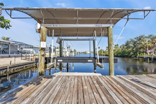 view of dock with boat lift and a water view