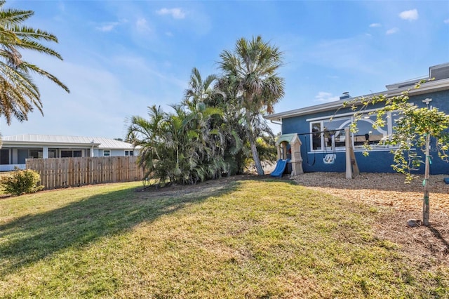 view of yard with a playground and fence