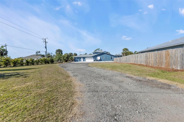 view of street with gravel driveway