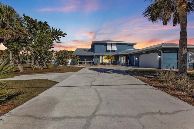 view of front of house with concrete driveway and an attached garage