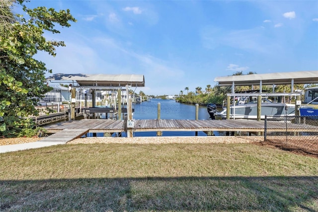 dock area with a yard, a water view, and boat lift