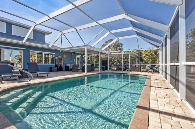 pool with glass enclosure and a patio