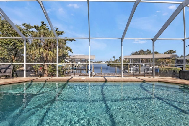 pool featuring a lanai, boat lift, and a dock