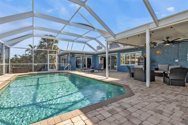 pool featuring an outdoor living space, a patio, a lanai, and a ceiling fan