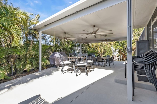 view of patio featuring outdoor dining space, grilling area, and ceiling fan