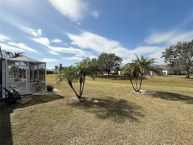 view of yard featuring glass enclosure