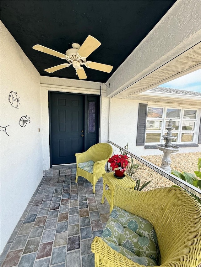 view of exterior entry with ceiling fan