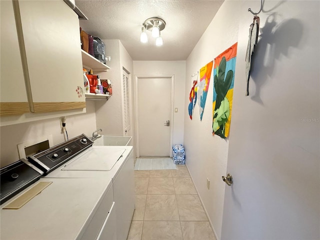 laundry room featuring sink, a textured ceiling, washing machine and dryer, and light tile patterned floors