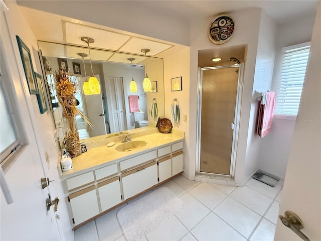 bathroom with toilet, tile patterned flooring, an enclosed shower, and vanity