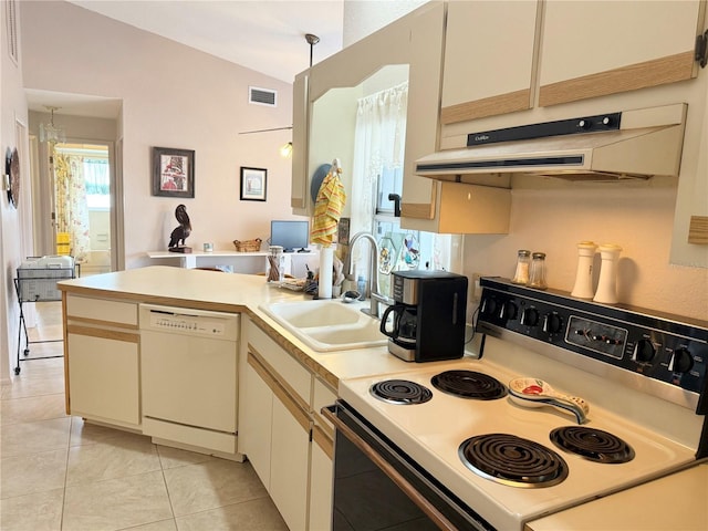 kitchen featuring kitchen peninsula, pendant lighting, vaulted ceiling, sink, and white appliances