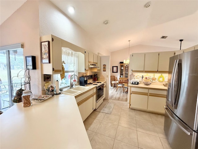 kitchen with lofted ceiling, white range with electric cooktop, hanging light fixtures, stainless steel fridge, and cream cabinets