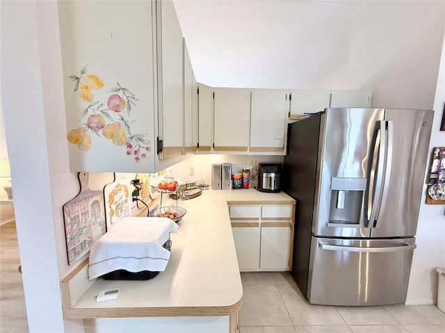 kitchen featuring stainless steel refrigerator with ice dispenser and light tile patterned flooring