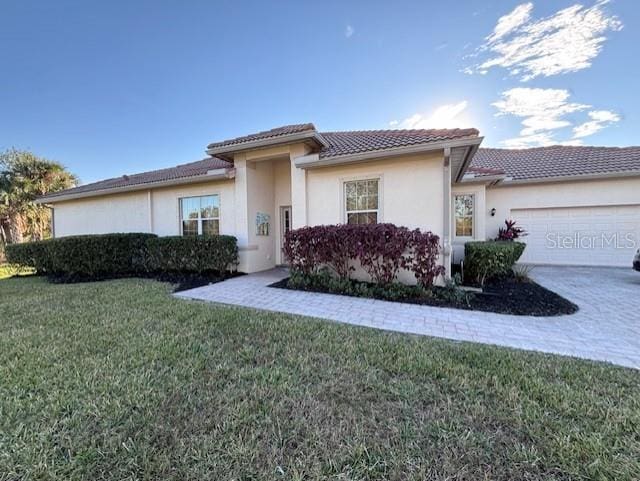 view of front of property with a front yard and a garage