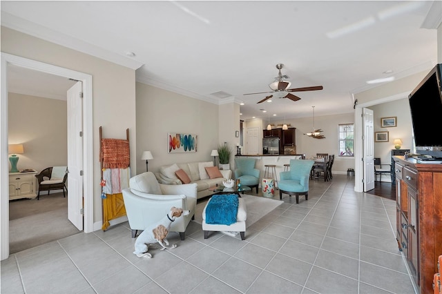 tiled living room featuring ceiling fan and ornamental molding