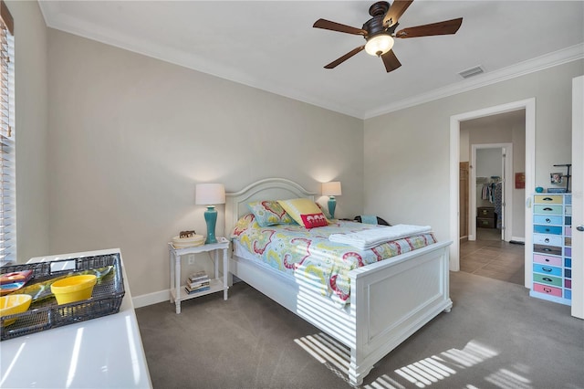 carpeted bedroom with ceiling fan and crown molding