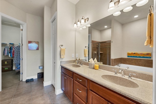 bathroom featuring tile patterned flooring, vanity, and separate shower and tub