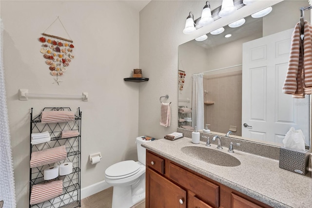 bathroom featuring tile patterned flooring, vanity, toilet, and curtained shower