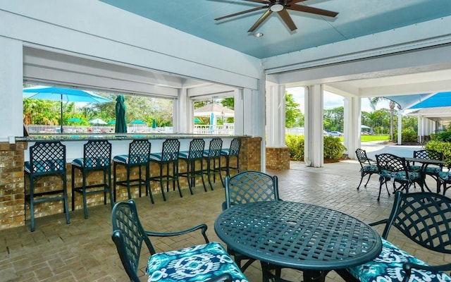 sunroom featuring ceiling fan